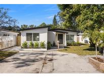 Charming, well-maintained one-story home featuring a crisp white exterior, manicured landscaping, and a concrete driveway at 3412 71St N St, St Petersburg, FL 33710