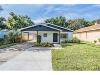 Charming one-story home boasts fresh landscaping, a carport, and a freshly painted exterior at 3908 W Laurel St, Tampa, FL 33607