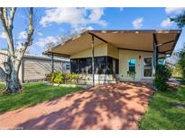 Charming single-story home featuring a covered porch, landscaped yard, and cozy curb appeal at 411 Dolphin S Dr, Oldsmar, FL 34677