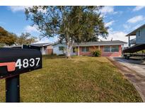 Charming red brick home featuring a spacious yard and mature tree at 4837 97Th N Way, St Petersburg, FL 33708