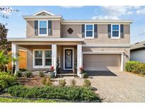 Charming two-story home featuring a landscaped yard, covered porch, and a two-car garage at 5134 Ballantrae Blvd, Land O Lakes, FL 34638