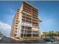 An attractive, modern high-rise building with multiple balconies and palm trees in a well-maintained community at 5396 Gulf Blvd # 110, St Pete Beach, FL 33706