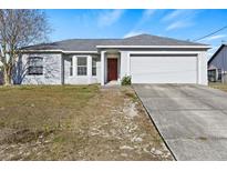 Charming single-story home featuring a two-car garage, a well-maintained lawn and mature trees at 9117 Northcliffe Blvd, Spring Hill, FL 34606