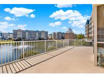 Relaxing balcony space overlooking a serene pond and fountain with residential buildings at 960 Starkey Rd # 3106, Largo, FL 33771