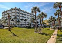 A well maintained building exterior featuring lush landscaping and an inviting entrance on a sunny day at 100 Bluff View Dr # 514A, Belleair Bluffs, FL 33770