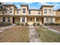 Inviting townhome exterior with manicured landscaping and a charming walkway, perfect for a comfortable living at 10944 Keys Gate Dr, Riverview, FL 33579