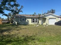 Charming single-story home featuring a well-maintained lawn and an attached one-car garage at 1156 Poinciana Rd, Venice, FL 34293