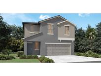 Two-story home showcasing a neutral color scheme, two-car garage, and manicured landscaping at 13553 Newbridge St, Spring Hill, FL 34609