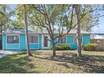 Charming single-story home with bright blue siding and mature landscaping in a desirable neighborhood at 622 Bay Lake Trl, Oldsmar, FL 34677
