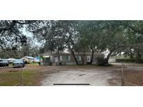 Charming single-story home with mature trees, a large lot, and ample parking at 12205 Greenland Dr, Riverview, FL 33579