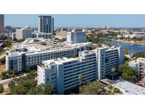 High-angle view of gray condo building at One Laurel Place in an urban setting, with rooftop parking at 201 W Laurel St # 507, Tampa, FL 33602