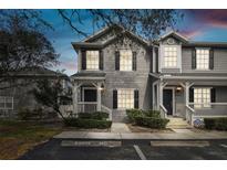 Charming two-story townhome featuring a well-maintained facade, inviting entrance, and manicured landscaping at 4927 Elizabeth Anne Cir, Tampa, FL 33616