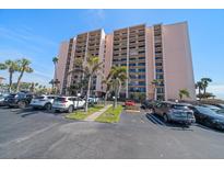 Multi-story condo building with manicured landscaping, private balconies and ample parking at 51 Island Way # 308, Clearwater Beach, FL 33767