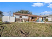 Charming single-story home with a fenced yard and unique decor on a sunny day at 539 Freeport N Ave, St Petersburg, FL 33702