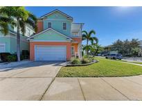 Beautiful two-story home features lush landscaping, a spacious driveway, and a welcoming front porch, perfect for families at 6571 Simone Shores Cir, Apollo Beach, FL 33572