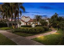 Charming home featuring lush landscaping, a red tile roof, and a welcoming garden path at 719 21St N Ave, St Petersburg, FL 33704