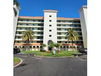 Beautiful condo building with classic design, lush landscaping, and roundabout entrance at 4801 Osprey S Dr # 209, St Petersburg, FL 33711