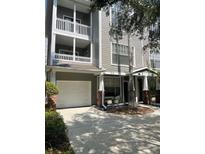 Two-story townhouse with a garage, covered front porch, and balcony at 809 S Oregon Ave # A, Tampa, FL 33606