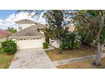 Charming home showcasing a two-car garage, well-maintained landscaping, and a welcoming front entrance at 11116 Rodeo Ln, Riverview, FL 33579