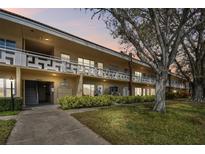 Well-maintained condo building with lush landscaping, offering a serene community setting at 2280 World Parkway Blvd # 34, Clearwater, FL 33763