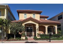 Charming two-story home featuring a terracotta roof, arched entry, and manicured landscaping at 249 Iron Age St., Safety Harbor, FL 34695