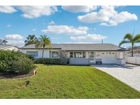 Charming single-story home with manicured lawn, updated exterior paint, and a welcoming entryway at 2851 66Th N Way, St Petersburg, FL 33710