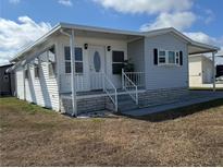 Charming single-story home with a covered porch and well-maintained facade at 4845 Baker Ave, Zephyrhills, FL 33541