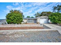 Charming single-story home with well-manicured front yard, featuring a driveway and attached garage at 5313 Baroque Dr, Holiday, FL 34690