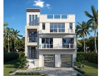 Modern three-story home featuring a minimalist design, balconies, and a two-car garage at 561 173Rd E Ave, North Redington Beach, FL 33708