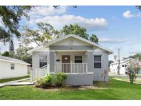 Charming home featuring a covered front porch, fresh landscaping, and a freshly painted exterior at 701 15Th S Ave, St Petersburg, FL 33701