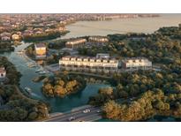 Stunning aerial view of waterfront homes, showcasing the community's marina, lush landscaping, and access to waterways at 2 Aqua Reserve Blvd, New Port Richey, FL 34652