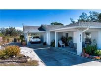 Well-maintained home with two carports, a spacious driveway, and a nicely landscaped front yard at 4010 N Lockwood Ridge Rd, Sarasota, FL 34234