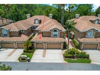 Beautifully landscaped, two-story townhome with a two-car garage and well-maintained lawn at 4224 Preserve Pl, Palm Harbor, FL 34685