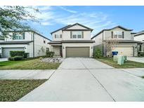 Charming two-story home featuring a well-maintained lawn and a two-car garage at 7673 Yale Harbor Dr, Wesley Chapel, FL 33545