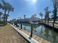Waterway in the community with tropical trees, boats docked along the side, and view of the condos at 1001 Inlet Cir # 169, Venice, FL 34285