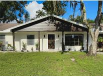 Charming single story home with well maintained front lawn and beautiful, mature landscaping at 19109 Sunlake Blvd, Lutz, FL 33558