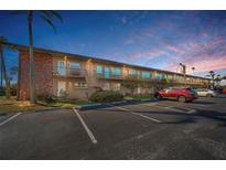 Charming two-story condo building featuring well-maintained landscaping and convenient parking at 2 Causeway Blvd # 208, Dunedin, FL 34698