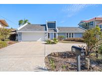 Charming single-Gathering home with two-car garage and well-maintained front yard at 41 Windward Is, Clearwater Beach, FL 33767