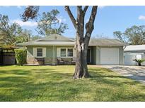 Charming single-story home with well-maintained lawn, seating area, and attached one-car garage at 534 Robin Hill Cir, Brandon, FL 33510
