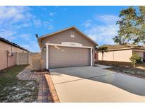 Single Gathering home with a two-car garage and neutral toned exterior at 13507 Mango Bay Dr, Riverview, FL 33579
