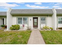 Charming single-story home featuring a well-manicured lawn and inviting front entrance at 4647 Lake Villa Dr, Clearwater, FL 33762