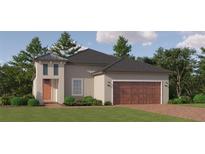 Charming home boasts a brick driveway and inviting exterior with lush landscaping and an attached two-car garage at 11870 Sparkling Topaz Cv, Parrish, FL 34219