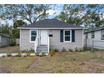 Charming home featuring gray siding, dark roof, and neatly landscaped front yard at 1931 24Th S St, St Petersburg, FL 33712