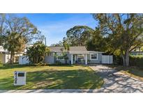 Charming single-story home with well-maintained lawn and lush landscaping at 4106 W Bay View Ave, Tampa, FL 33611