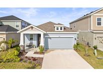 Charming single-Gathering home featuring a well-manicured lawn and attached two-car garage at 5914 Hidden Branch Dr, Apollo Beach, FL 33572