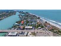 Beautiful aerial view showcasing the coastline and neighborhood, with a pin marking the property's location near the ocean at 136 93Rd Ave, Treasure Island, FL 33706