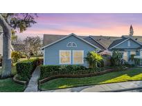 Charming single-story home with manicured landscaping and inviting curb appeal at dusk at 2473 Bentley Dr, Palm Harbor, FL 34684