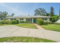 Charming single-story home featuring a well-manicured front lawn and an inviting blue front door at 306 Indian Rocks S Rd, Largo, FL 33770