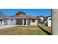 Charming single-story home with a covered front porch and well-maintained lawn on a sunny day at 4017 W Nassau St, Tampa, FL 33607