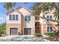 Charming condo with dual garages, private stairs, and a classic tile roof at 4106 Central Sarasota Pkwy # 1023, Sarasota, FL 34238